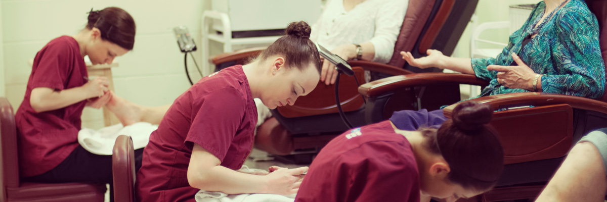 Estheticians giving pedicures to clients